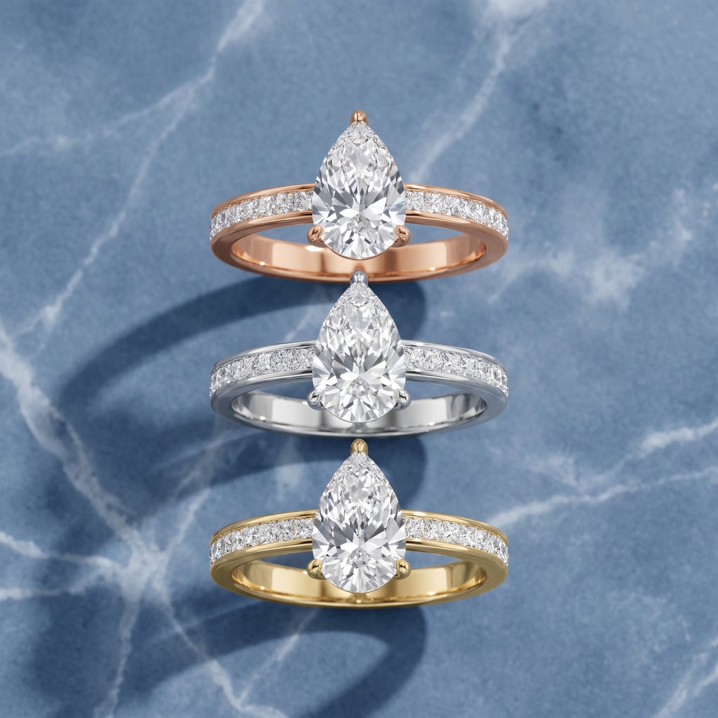 Brielle Channel Set Solitaire Pear Diamond Ring in Yellow Gold - 3rings.jpg