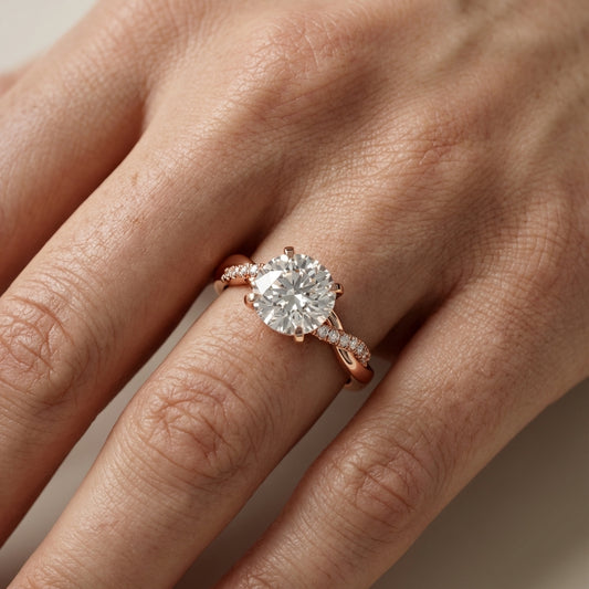 Round cut lab grown diamond twisted side stone engagement ring in rose gold