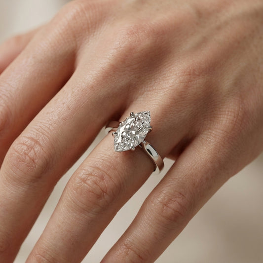 Marquise cut lab grown diamond solitaire engagement ring in polished silver setting.