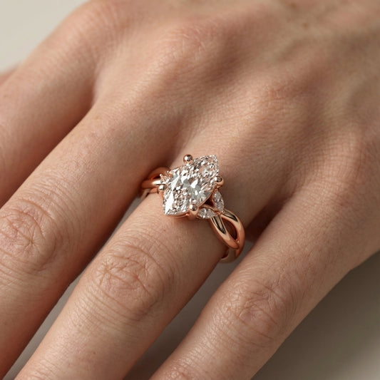 Marquise Cut Lab Grown Diamond Twisted Engagement Ring in Rose Gold with side stones