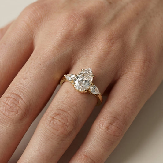 Pear Cut Lab Grown Diamond Three Stone Engagement Ring in Yellow Gold