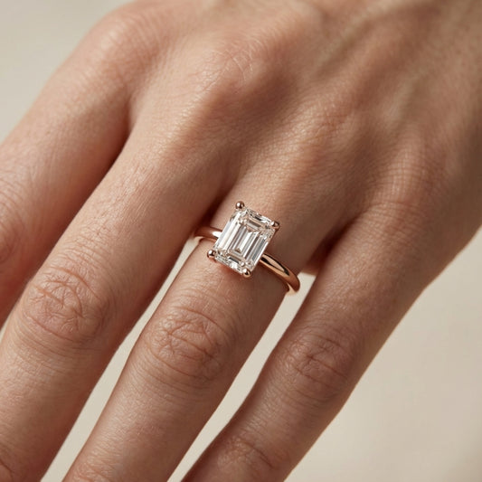 Emerald Cut Lab Grown Diamond Solitaire Engagement Ring in warm Rose Gold setting.