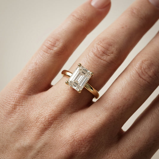 Emerald Cut Lab Grown Diamond Solitaire Engagement Ring in traditional Yellow Gold setting.