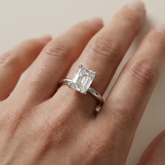 Emerald Cut Lab Grown Diamond Solitaire Engagement Ring in Polished Silver claw setting.