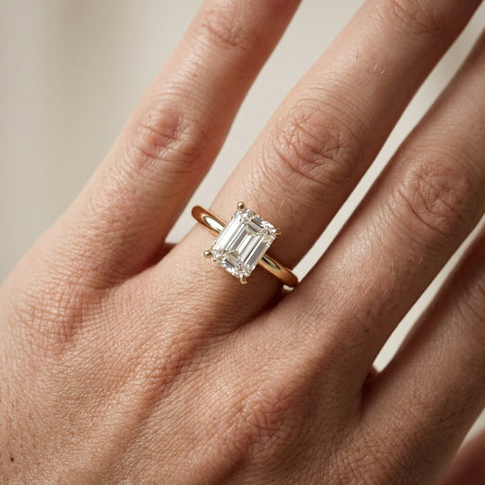 Emerald Cut Lab Grown Diamond Solitaire Engagement Ring in Yellow Gold showing cathedral setting