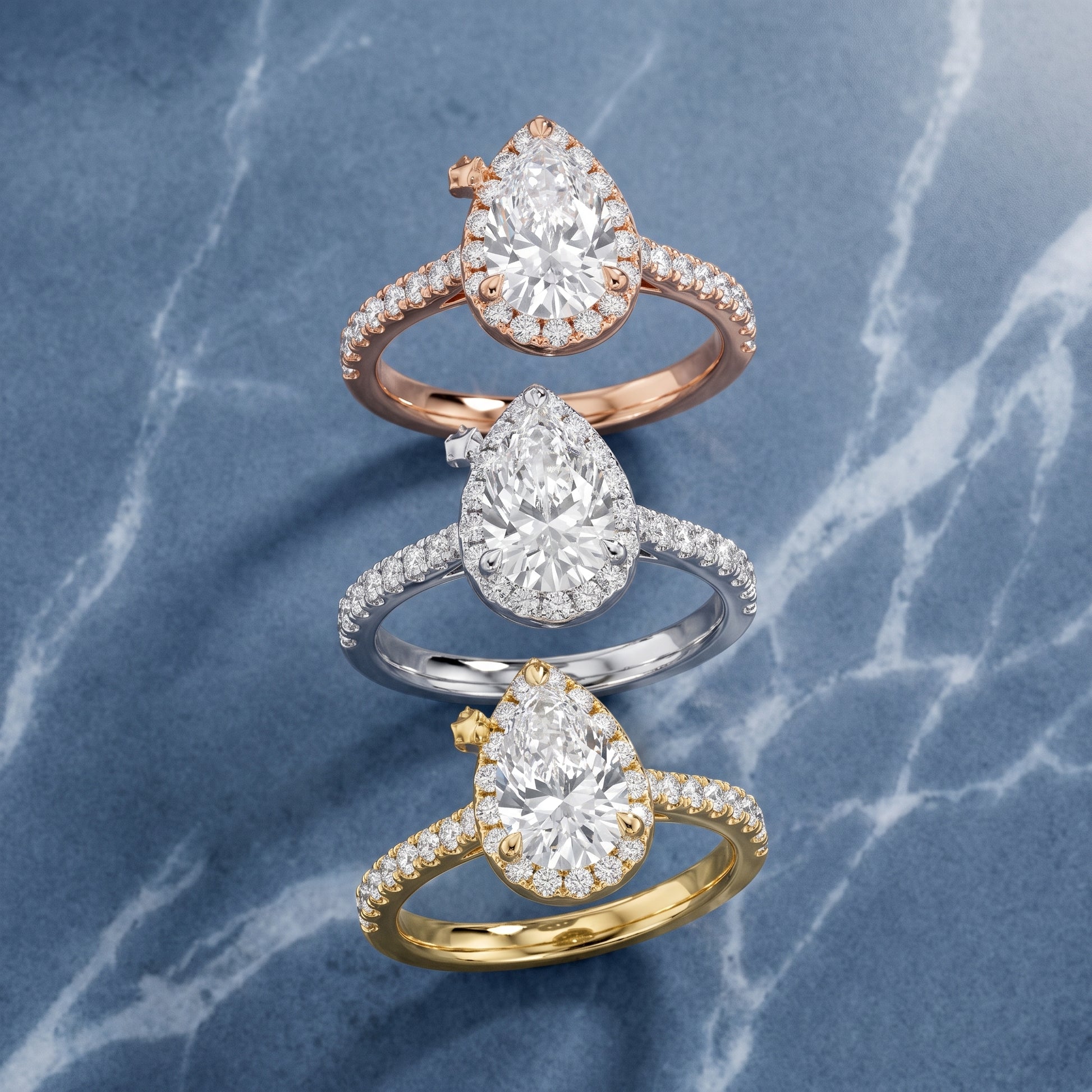 Amara Halo Claw Prong Pear Diamond Ring in Yellow Gold - 3rings.jpg
