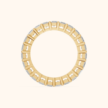 Callia Shared Prong Emerald Diamond Eternity Band in Yellow Gold - FingerView