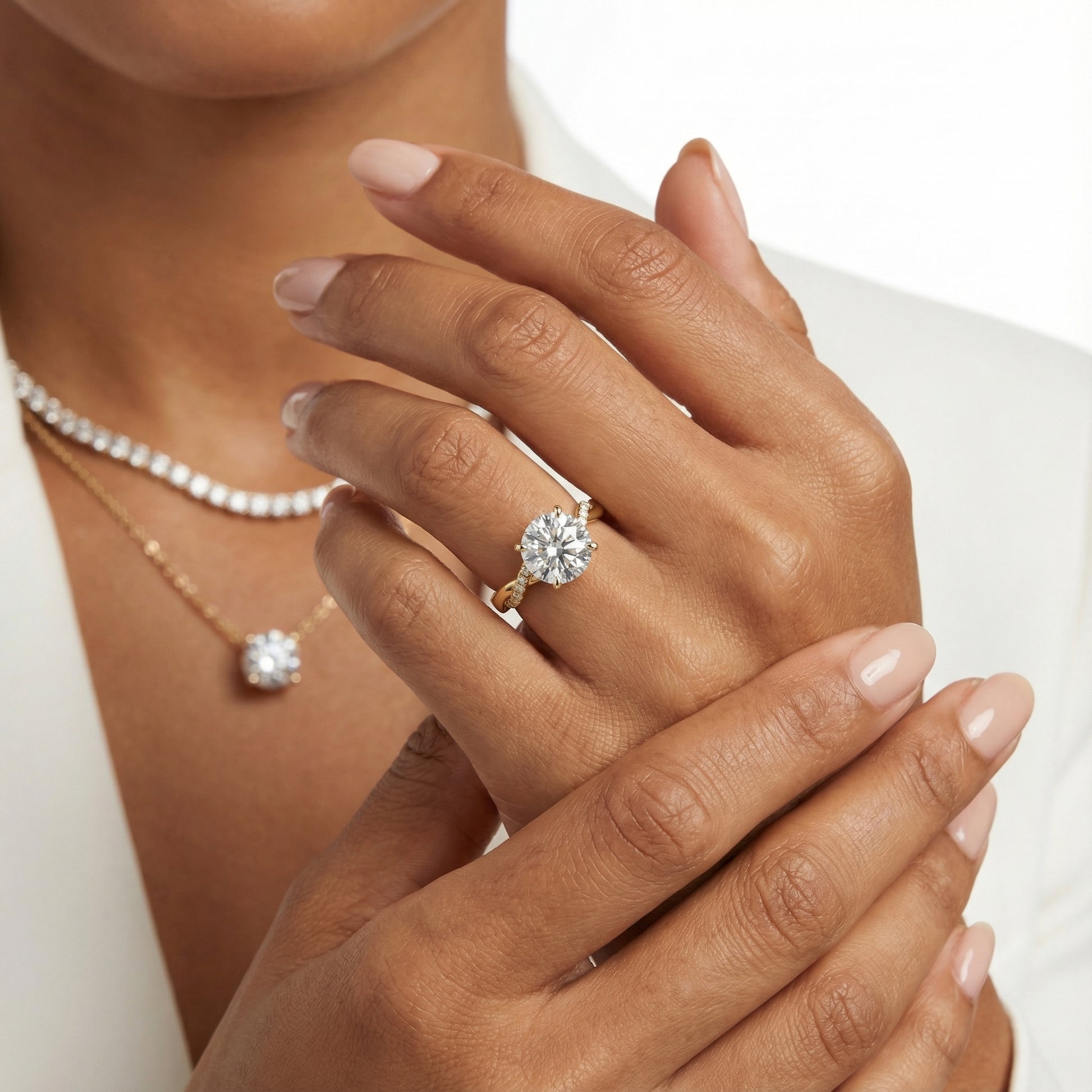 Round cut lab grown diamond twisted side stone engagement ring in yellow gold