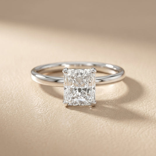 Charlotte Charm Radiant Cut Lab Grown Diamond Solitaire Engagement Ring in White Gold with four claw prongs.