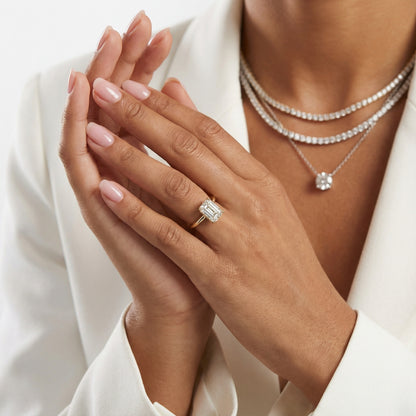 Emerald Cut Lab Grown Diamond Solitaire Engagement Ring in Yellow Gold on a light background