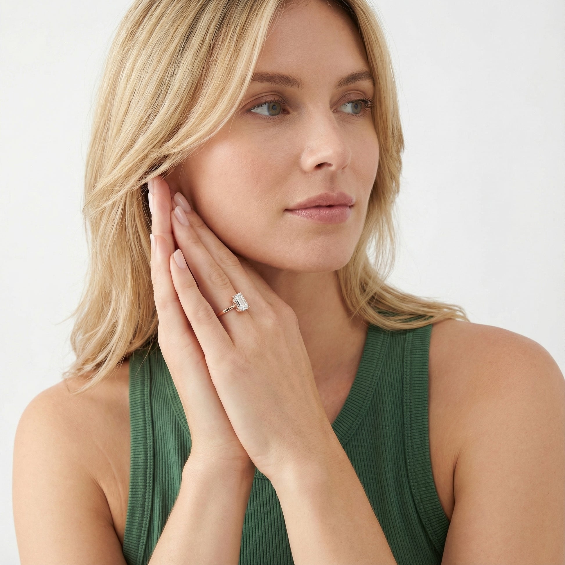 Emerald Cut Lab Grown Diamond Solitaire Engagement Ring in Rose Gold showing side profile with hidden accents