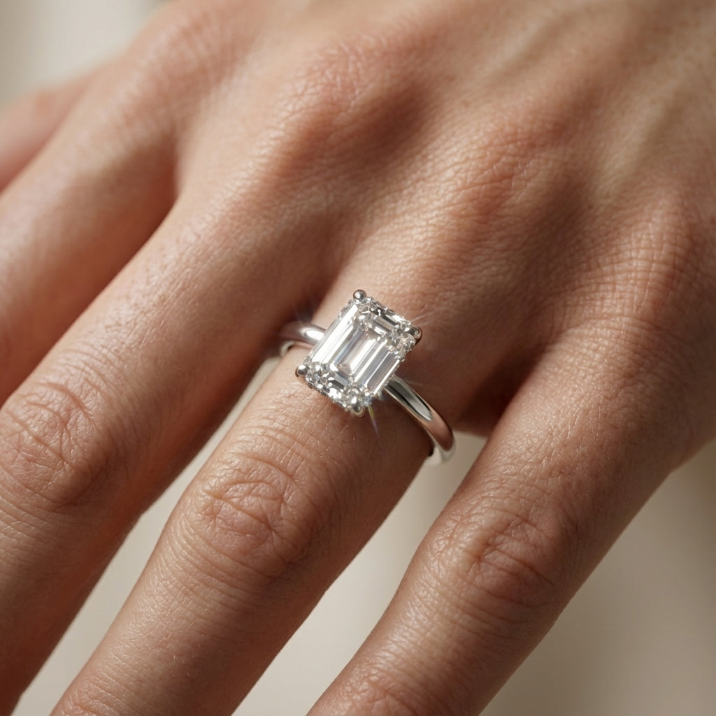 Emerald Cut Lab Grown Diamond Solitaire Engagement Ring in White Gold with four claw prongs