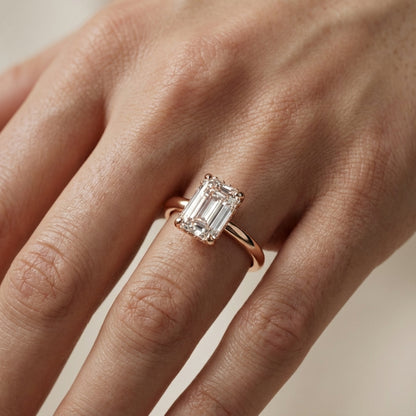 Emerald Cut Lab Grown Diamond Solitaire Engagement Ring in Rose Gold showing side profile with hidden accents