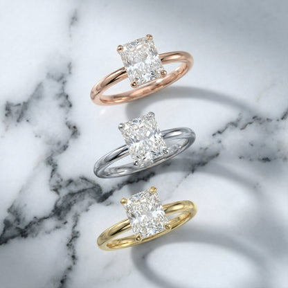 Charlotte Charm Radiant Cut Lab Grown Diamond Solitaire Engagement Ring in White Gold with four claw prongs.