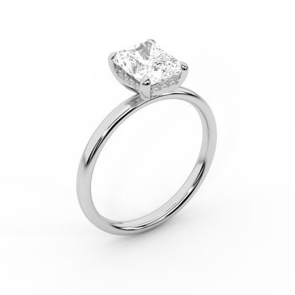 Charlotte Charm Radiant Cut Lab Grown Diamond Solitaire Engagement Ring in White Gold with four claw prongs.