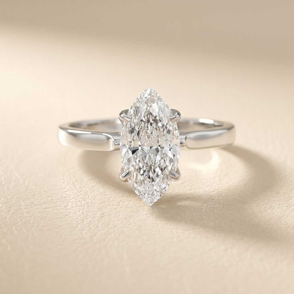Marquise cut lab grown diamond solitaire engagement ring in polished silver setting.