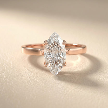 Marquise cut lab grown diamond solitaire engagement ring in warm rose gold floral setting.
