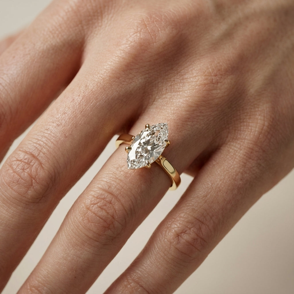 Marquise cut lab grown diamond solitaire engagement ring in rich yellow gold setting.