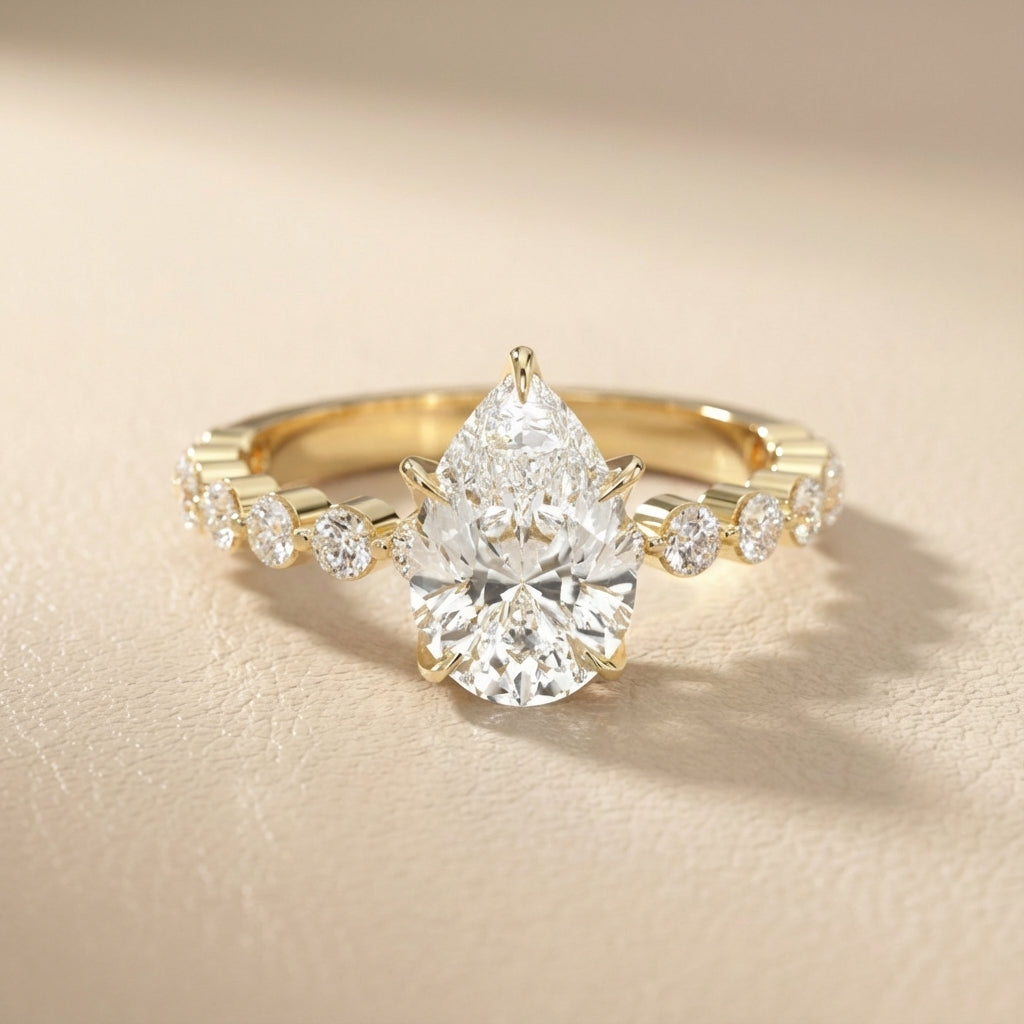 Pear Cut Lab Grown Diamond Engagement Ring with floating side stones in Yellow Gold