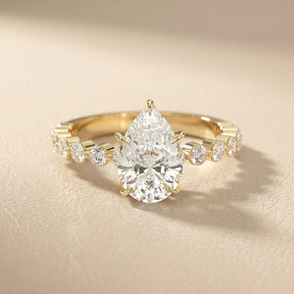 Pear Cut Lab Grown Diamond Engagement Ring with floating side stones in Yellow Gold