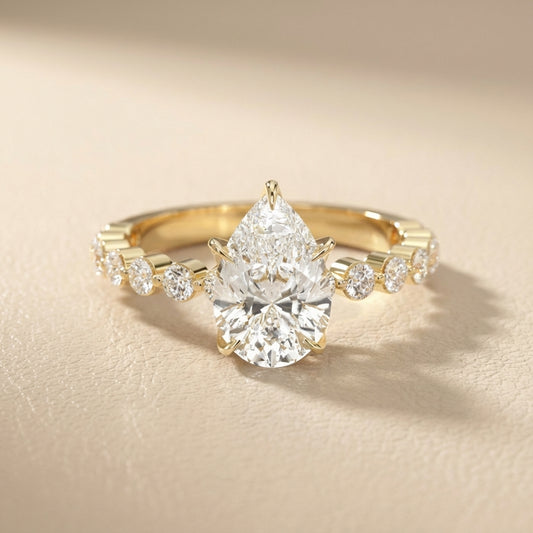 Pear Cut Lab Grown Diamond Engagement Ring with floating side stones in Yellow Gold