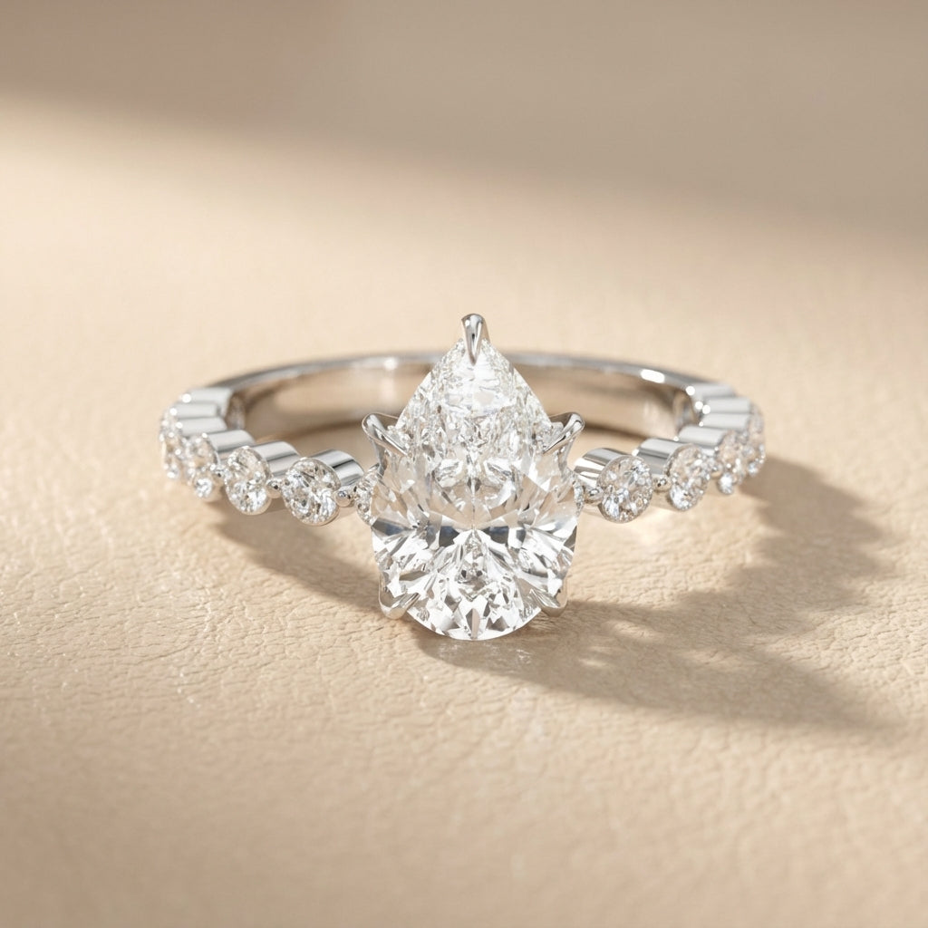 Pear Cut Lab Grown Diamond Engagement Ring with floating side stones in Platinum