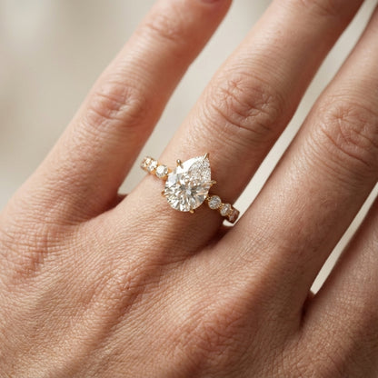 Pear Cut Lab Grown Diamond Engagement Ring with floating side stones in Yellow Gold