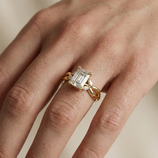 Emerald Cut Lab Grown Diamond Twisted Engagement Ring in Yellow Gold with Marquise Side Stones
