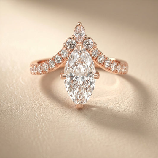 Rose gold engagement ring featuring a marquise cut lab grown diamond and intricate side stone details.