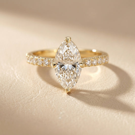 Traditional yellow gold engagement ring with a marquise cut lab grown diamond and side stone detailing.