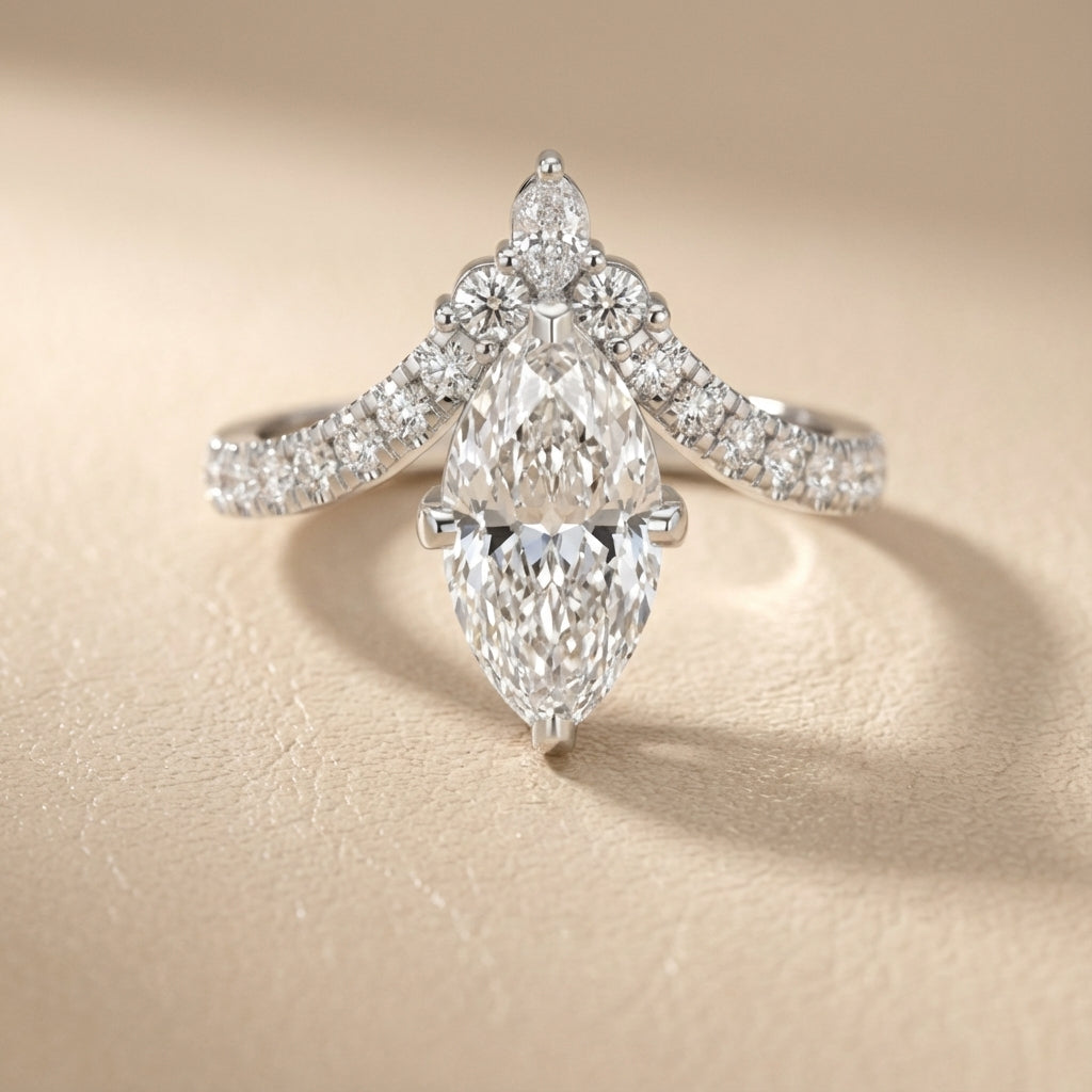 Platinum engagement ring showcasing a marquise cut lab grown diamond with pave side stones.