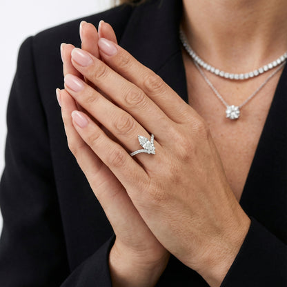 Marquise cut lab grown diamond engagement ring with side stones in a polished silver setting.