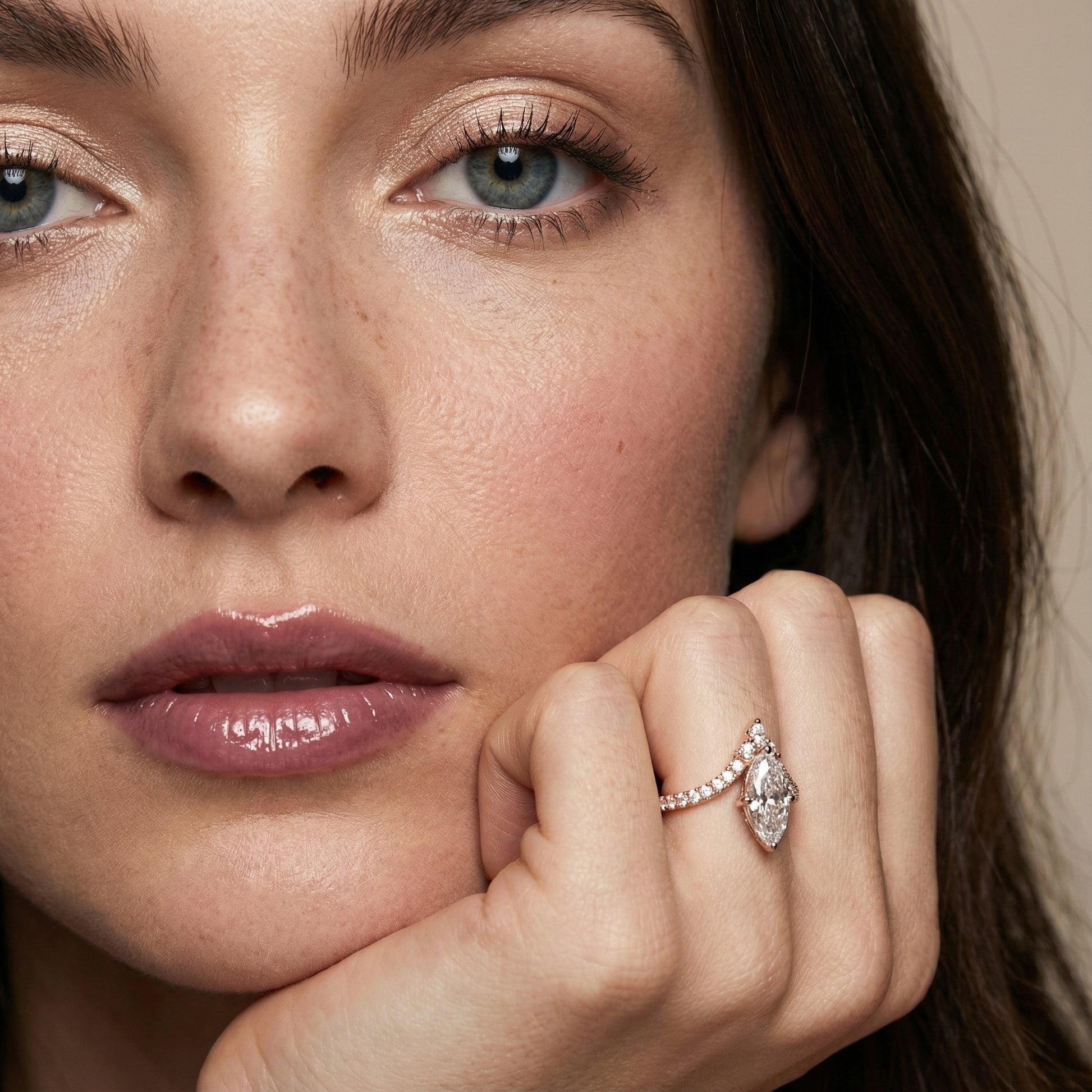 Rose gold engagement ring featuring a marquise cut lab grown diamond and intricate side stone details.