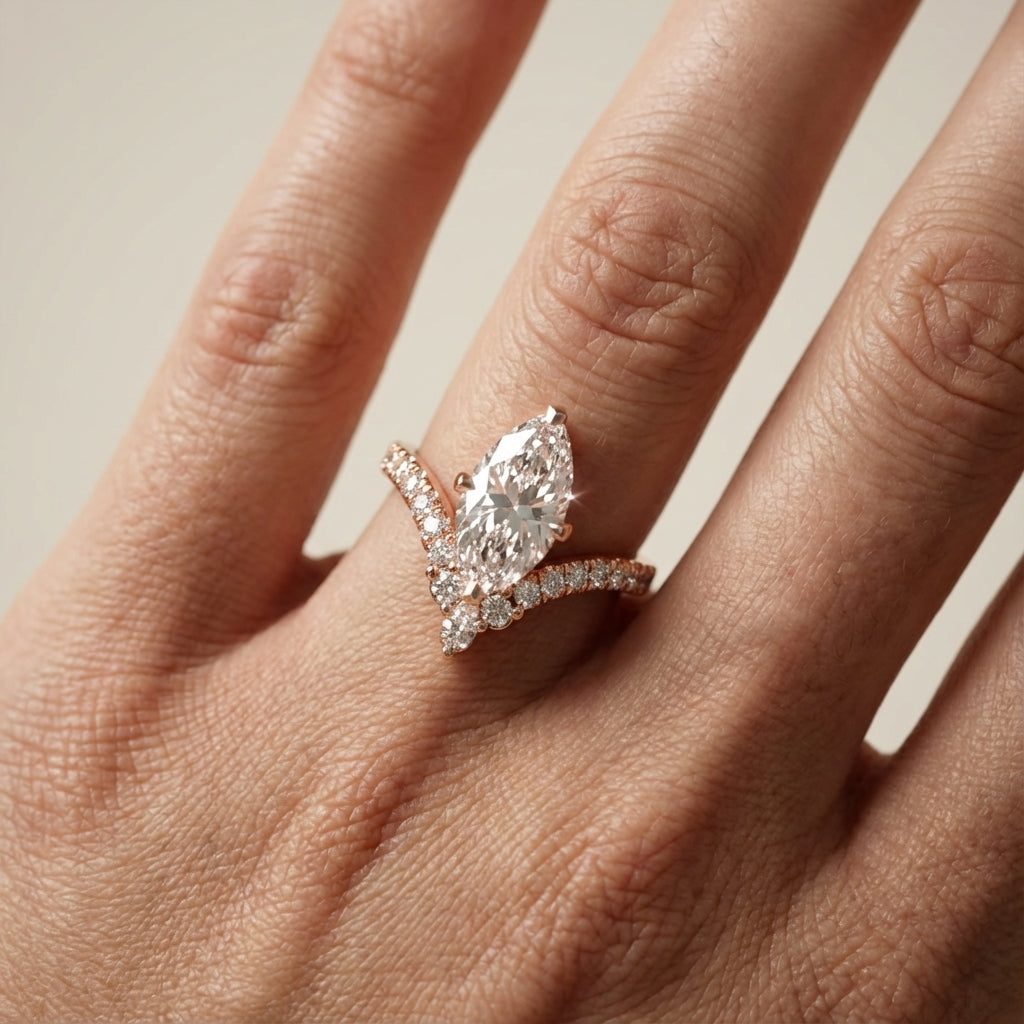 Rose gold engagement ring featuring a marquise cut lab grown diamond and intricate side stone details.