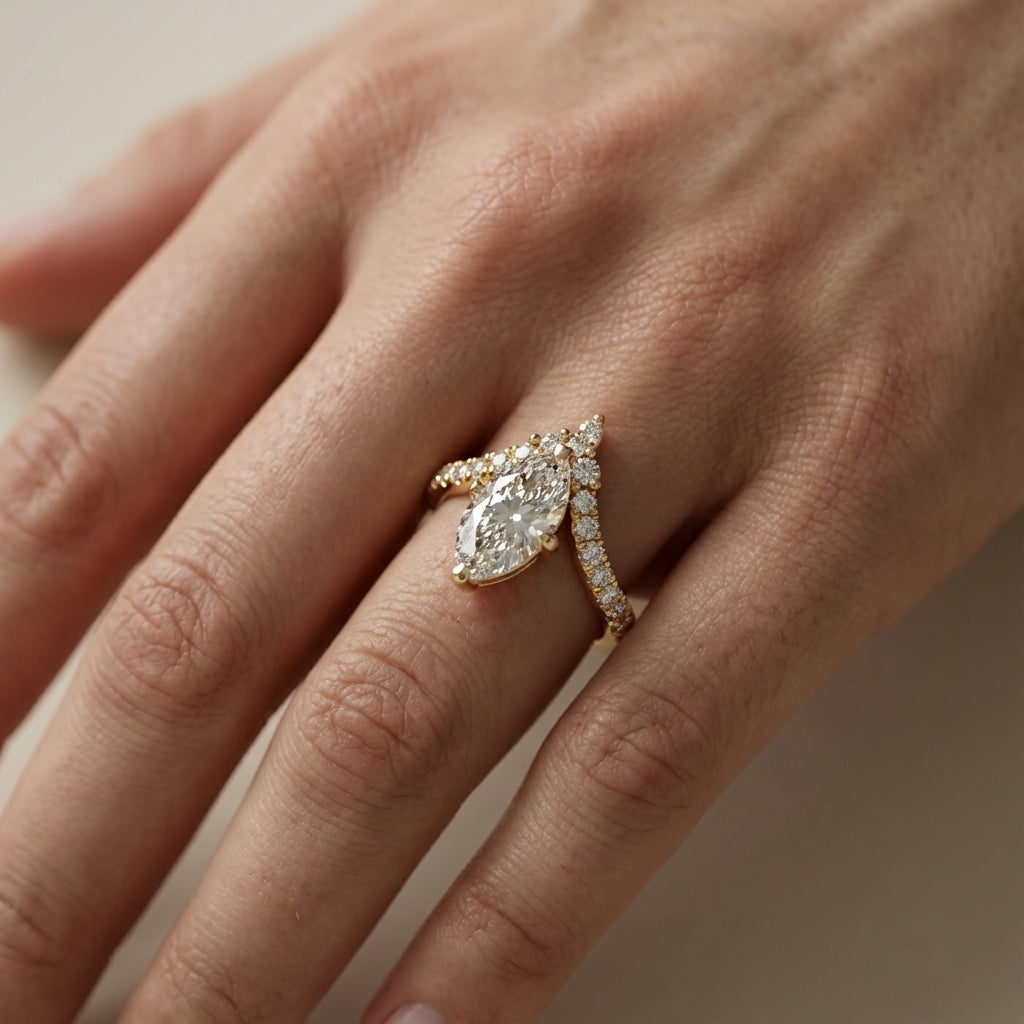 Traditional yellow gold engagement ring with a marquise cut lab grown diamond and side stone detailing.