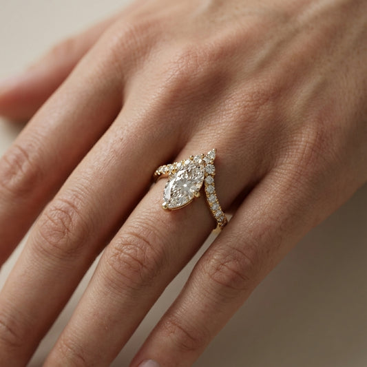 Traditional yellow gold engagement ring with a marquise cut lab grown diamond and side stone detailing.