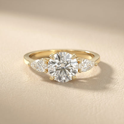 Round cut lab grown diamond three stone engagement ring in yellow gold setting