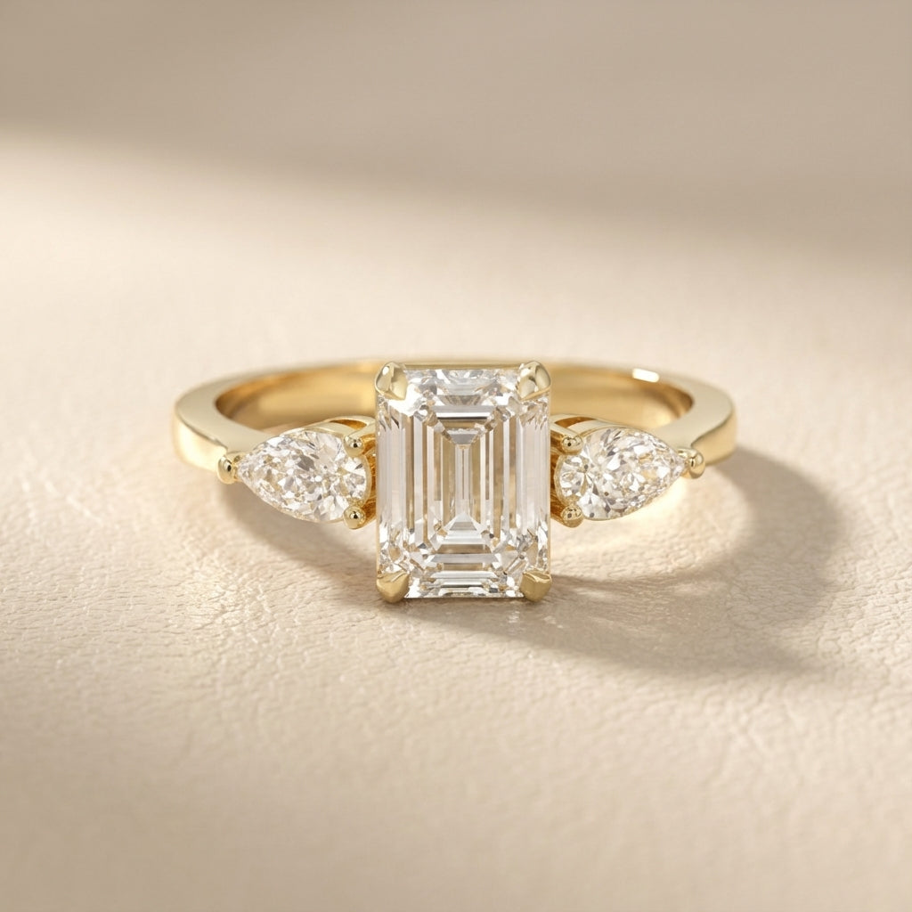 Grace Three Stone Emerald Cut Lab Grown Diamond Engagement Ring set in Yellow Gold