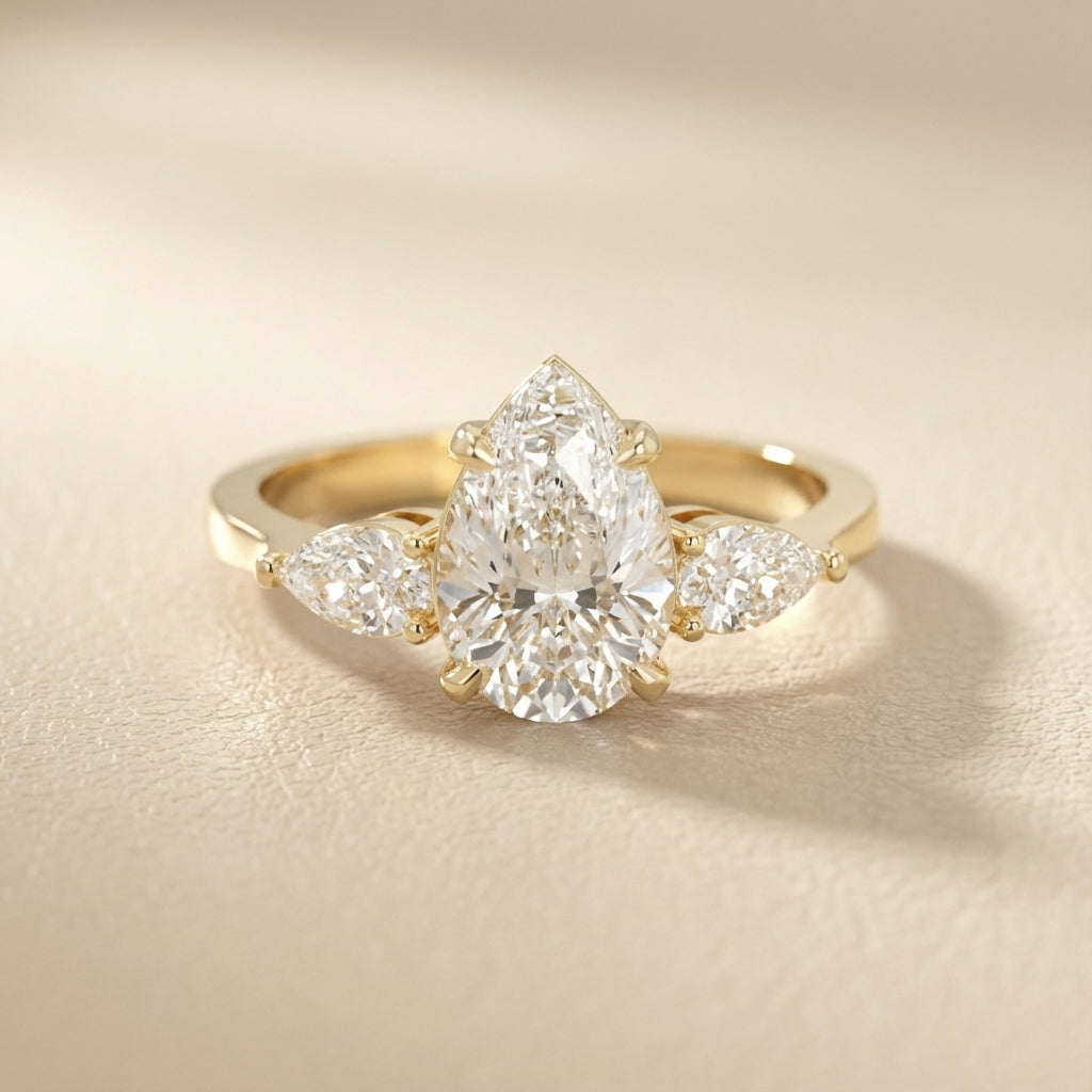Pear Cut Lab Grown Diamond Three Stone Engagement Ring in Yellow Gold