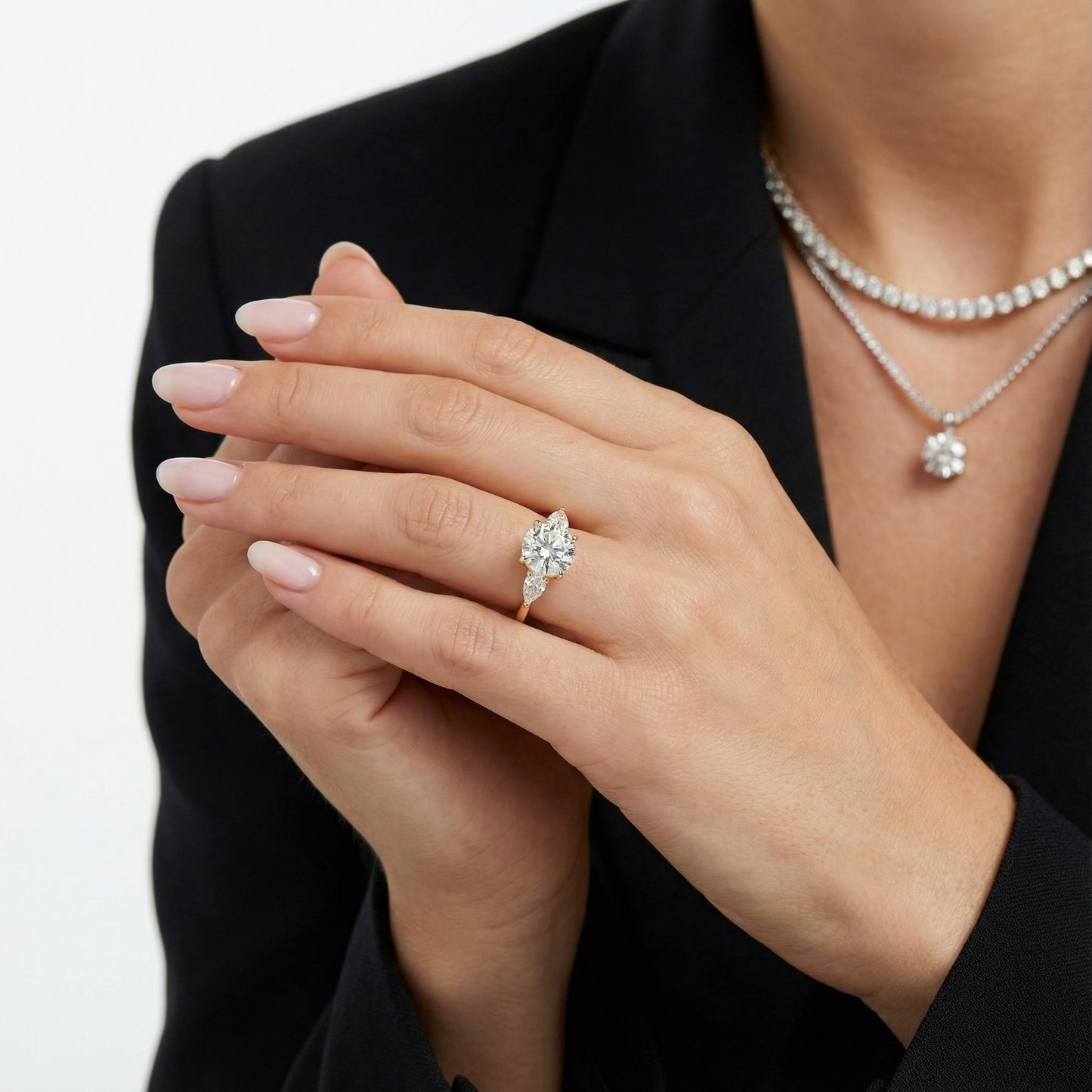 Round cut lab grown diamond three stone engagement ring in yellow gold setting