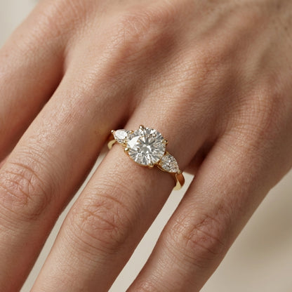 Round cut lab grown diamond three stone engagement ring in yellow gold setting