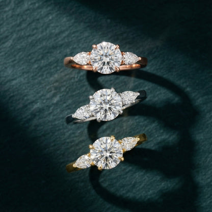 Round cut lab grown diamond three stone engagement ring in yellow gold setting