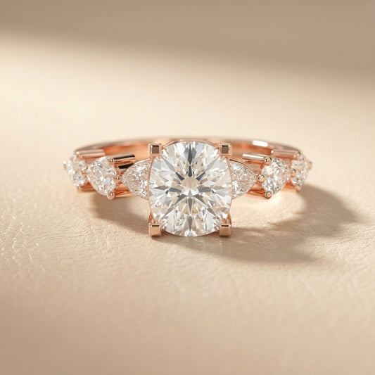 Cushion cut lab grown diamond engagement ring with marquise and pear side stones set in warm rose gold.