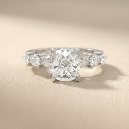 Cushion cut lab grown diamond engagement ring with marquise and pear side stones set in gleaming white gold.
