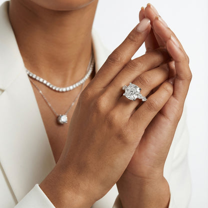 Cushion cut lab grown diamond engagement ring with marquise and pear side stones set in enduring platinum.