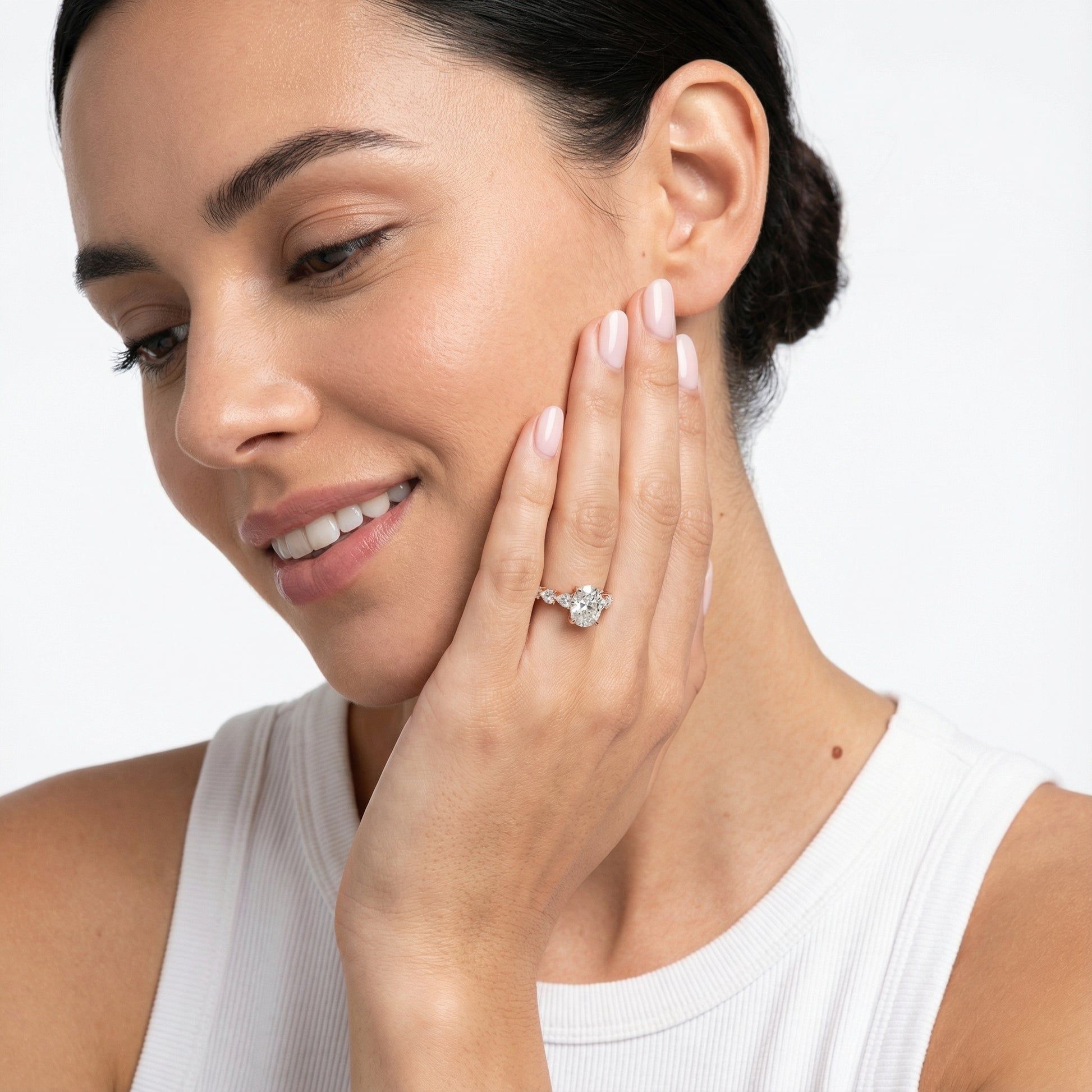 Cushion cut lab grown diamond engagement ring with marquise and pear side stones set in warm rose gold.