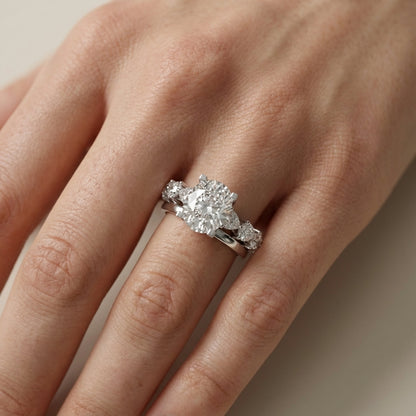 Cushion cut lab grown diamond engagement ring with marquise and pear side stones set in gleaming white gold.