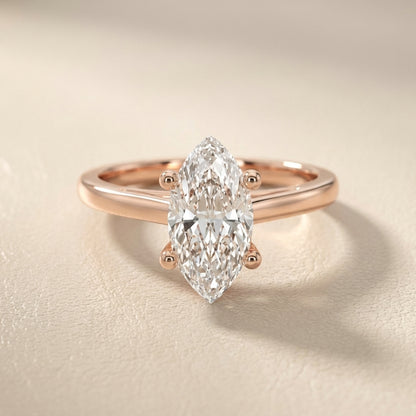 Rose Gold Marquise Cut Lab Grown Diamond Solitaire Engagement Ring with hidden scrollwork underneath.