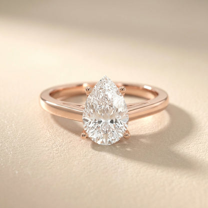 Pear Cut Lab Grown Diamond Solitaire Engagement Ring in Rose Gold showing side profile scrollwork