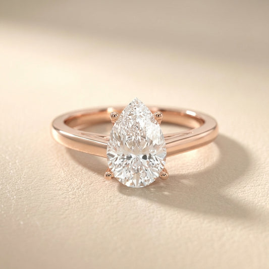Pear Cut Lab Grown Diamond Solitaire Engagement Ring in Rose Gold showing side profile scrollwork